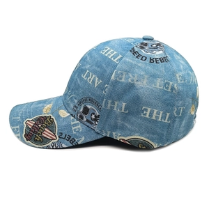 Close-up detail of blue denim baseball cap with vintage letters and street style patches