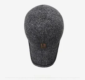 Top view of dark grey winter baseball cap with knit texture and leather logo detail