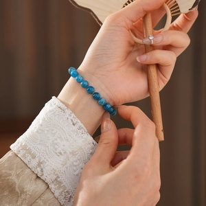 Blue apatite crystal beaded bracelet worn by a model in a quiet Chinese style scene