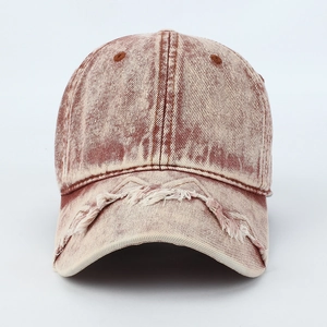 Detailed view of the distressed raw edges and washed denim texture on the retro baseball cap