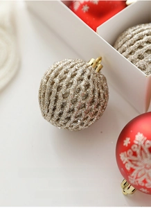 Detailed macro view of 6cm golden hollow glitter and red snowflake Christmas tree baubles