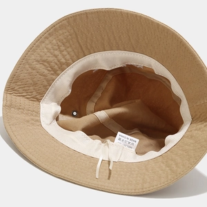 Internal view of khaki cotton bucket hat with sweatband, drawstring and wash label