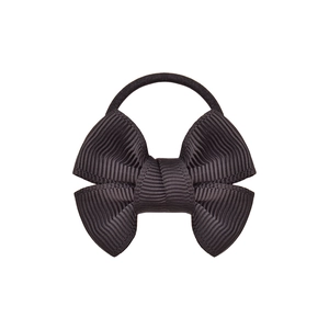 Detail of a black ribbon bow hair tie with smooth textile texture on white background