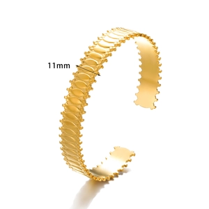 Detail of 11mm wide gold hollow heart cuff bracelet featuring embossed oval link patterns