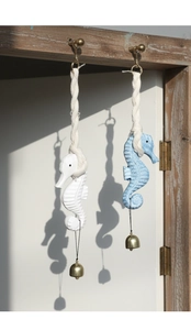 Detail showing hand-carved wooden seahorse ornaments with vintage metal bells