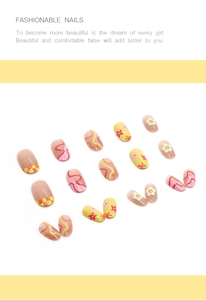 Detail of round press-on nails featuring yellow sun flowers, smiles and wave patterns