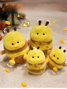 Detail of plush bee duck charms in four sizes featuring soft yellow fur and gold coin accents