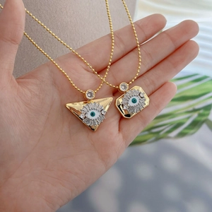 Vintage golden evil eye pendant necklaces in triangle and rectangle shapes with crystals