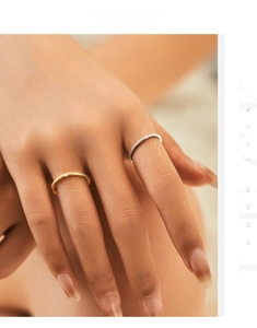 Detail of s925 silver cross rings in gold and silver finish with sparkling texture