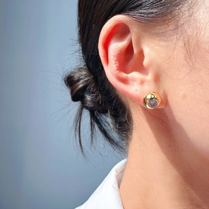 Elegant gold round stud earrings with a large sparkling purple zircon for daily wear