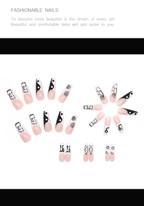 Detailed flat lay of long coffin press-on nails with black and white minimalist patterns