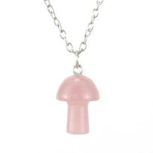 Macro detail of natural pink quartz mushroom pendant with a silver-colored chain