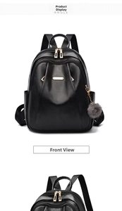Detail of black leather backpack featuring pleated texture and golden hardware accents