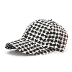 Detail of the thick checkered wool texture and curved brim of this plaid baseball cap