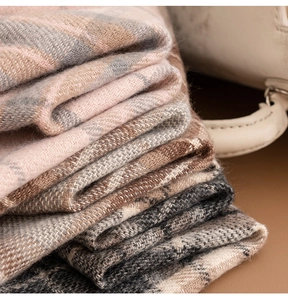 Close-up of soft plaid scarves in pink and brown with high-quality cashmere texture