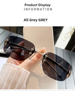 Detail of grey frameless Y2K sunglasses lens with silver star-shaped metal accents