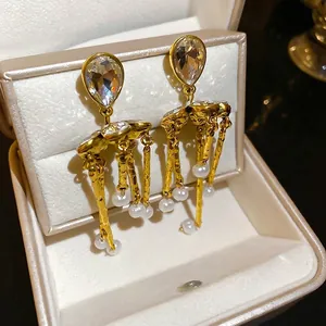 Vintage gold tassel earrings with crystal teardrop and pearls in a velvet jewelry box