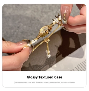 Macro detail of gold-tone round case with elegant pearl bracelet and adjustable slider