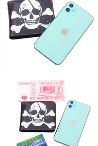 Detailed size comparison of a black bifold skull wallet with cards and a smartphone