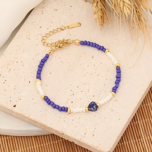 Detailed shot of bohemian beaded bracelet with blue heart stone and adjustable gold chain