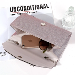 Pink glitter envelope clutch bag shown open with phone and sunglasses inside for capacity