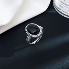 Dettaglio macro dell'anello in argento S925 con pietra nera ovale e trama incisa