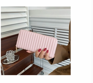 Close-up of pink quilted PU leather women's long wallet with elegant gold zipper detail