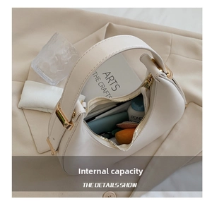 Detailed view of cream crescent bag interior showing storage space for daily essentials