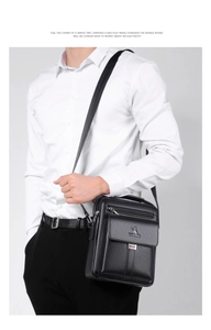 Detail view of black leather shoulder bag showing the luxury texture and brand logo