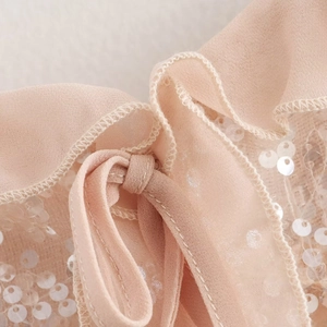 Pink sequined ruffle camisole with delicate mesh fabric and drawstring tie details