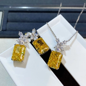 Detail of Radiant cut yellow gemstone jewelry set with marquise petal accents