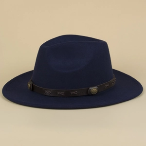 Detail of navy blue fedora featuring brown leather strap with bronze studs and stitching