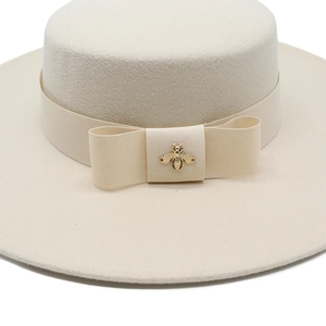 Elegant beige wool felt flat top boater hat with wide brim and golden bee metal buckle