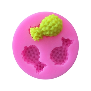 Detail of pink silicone mold with fruit and chicken drumstick shapes for cake decoration