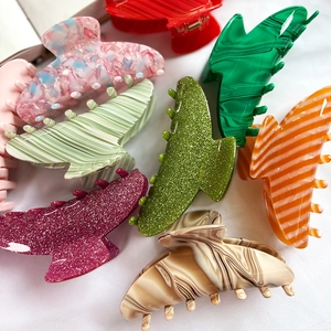 French style acetate hair claws in marble and glitter finishes for thick hair styling
