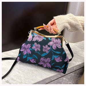 Detail of vintage Cheongsam handbag with 3D floral embroidery and wooden handle