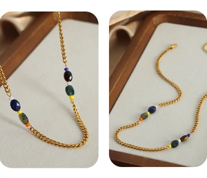 Detail of gold-plated Cuban chain necklace featuring colorful faceted natural stone beads
