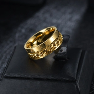 Macro shot of gold-plated spinner ring featuring Cuban chain and Roman numeral details