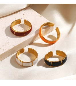 Detailed view of colorful enamel bamboo rings in dark red, orange, white and black colors