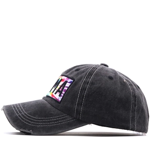 Detail of vintage washed baseball cap featuring contrast stitching and tie-dye patch