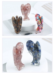 Detailed view of four handmade resin angel figurines filled with natural crystal stones
