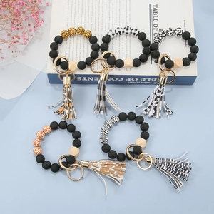 Beaded keychain bracelets with matte black beads and leopard print leather tassels