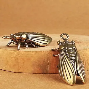 Vintage brass cicada charms on wood base with a realistic antique finish and hanging loop