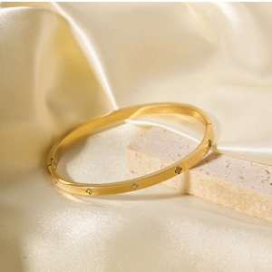 Dettaglio del bracciale a cerniera in acciaio inossidabile dorato con stelle di zircone