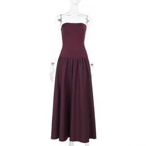 Detail of burgundy tube dress featuring cinched waist and pleated flared A-line long skirt