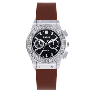 Jingis women's quartz watch with silver rhinestone bezel and brown silicone strap