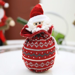 Red knitted Christmas gift bag with Santa Claus doll and drawstring closure for holidays