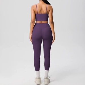 Detail of dark purple yoga set with thin straps sports bra and high waisted leggings