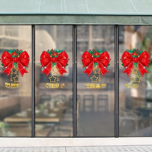 Christmas and New Year window stickers with red bows and festive green foliage