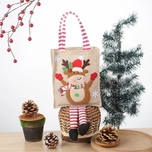 Christmas gift bag with 3D reindeer design on brown burlap material with red handles